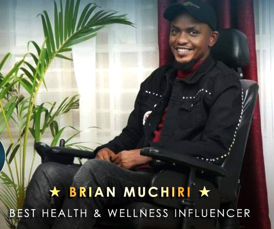 Screengrab of Brian Muchiri, seated in a power wheelchair. He wears a black jacket, a black cap, and a red turtleneck. Text on the image reads: "Brian Muchiri - Best Health & Wellness Influencer." 